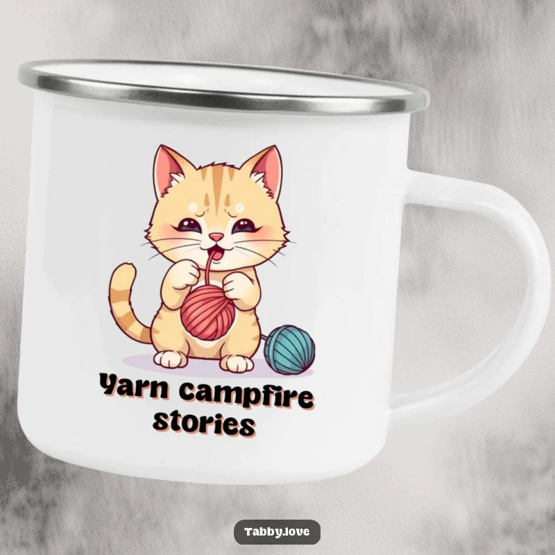 Funny Camping Mug: A mischievous cat batting playfully at a dangling ball of yarn outdoors.