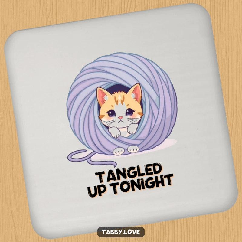 Funny cat yarn coaster with a curious kitten peeking playfully from behind a giant ball of yarn, protecting surfaces.